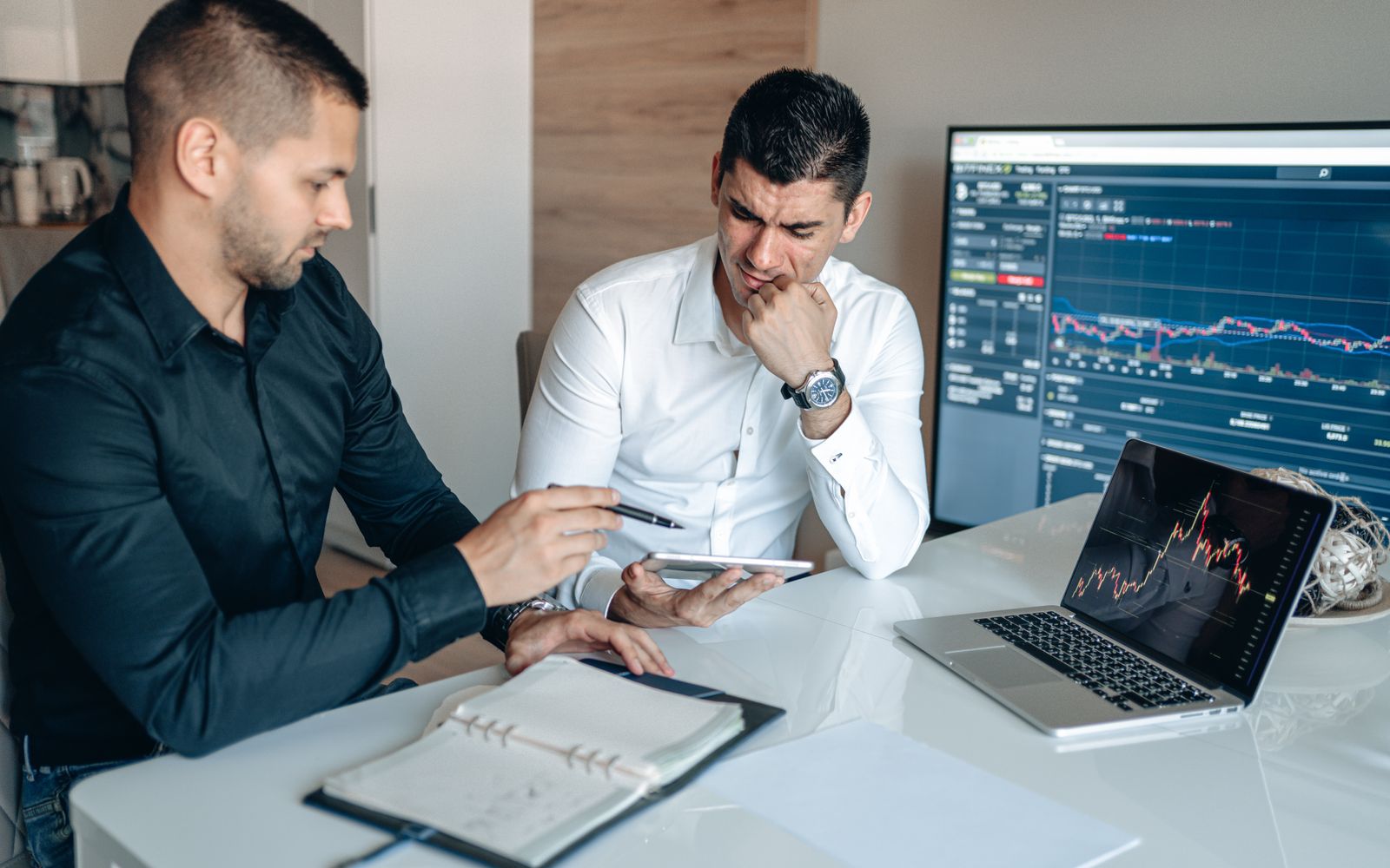 Two professionals reviewing digital access and business data