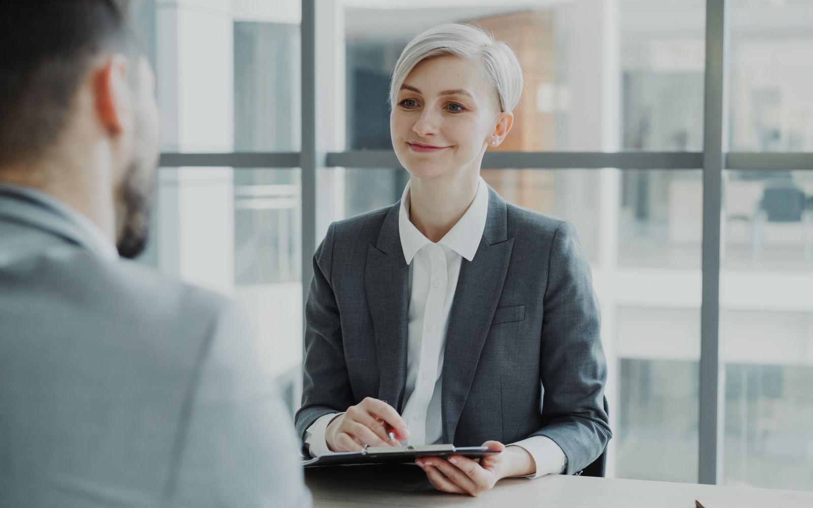 A recruiter interviewing a candidate in a modern office