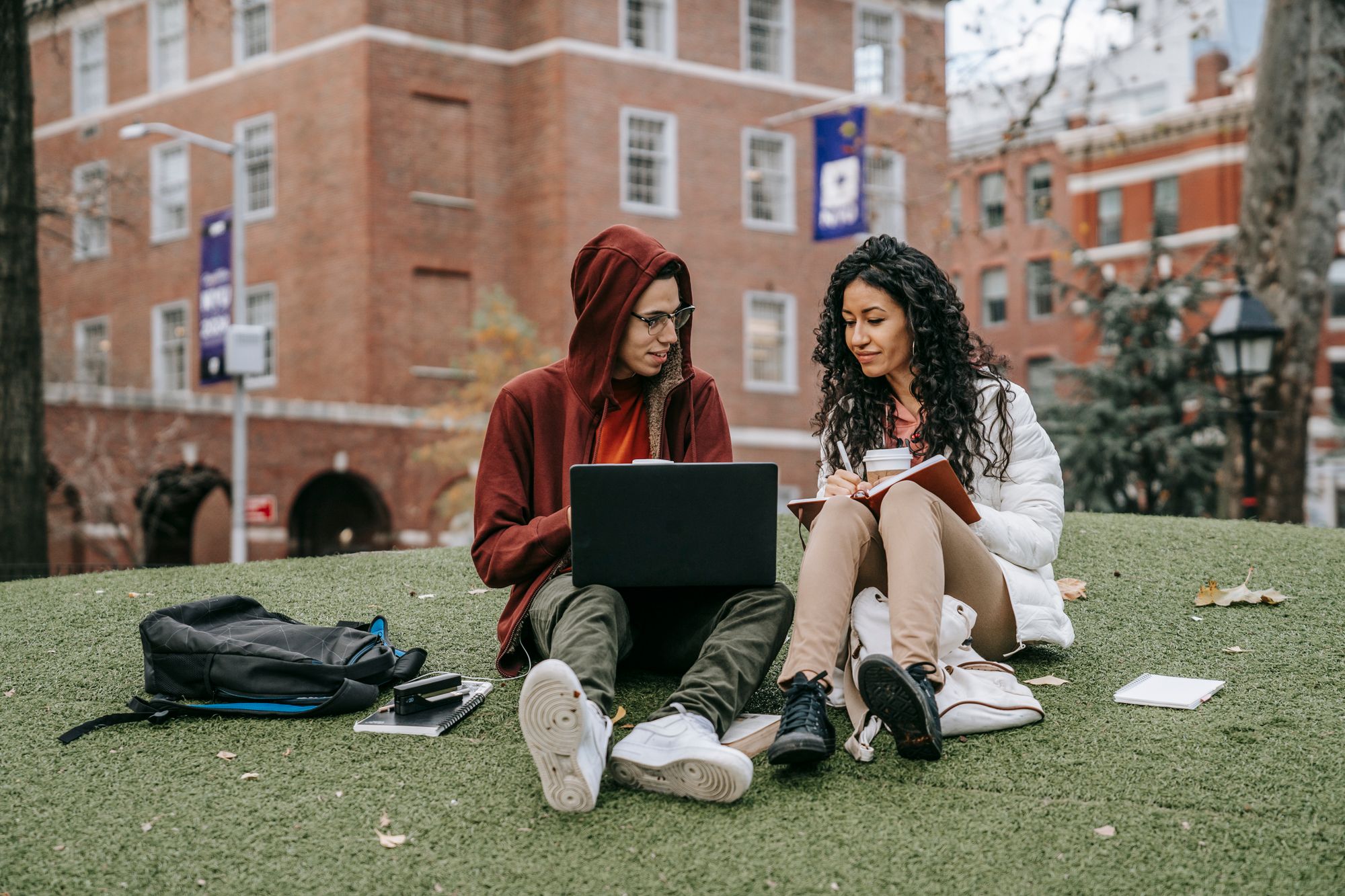 University students collaborating with a laptop on campus